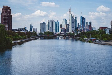 Fototapeta premium River with the Frankfurt city skyline in the background on a sunny day