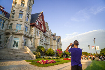 Tourist Taking a Photo with his Camera at the Palacio de la Magdalena de Santander from the Garden...