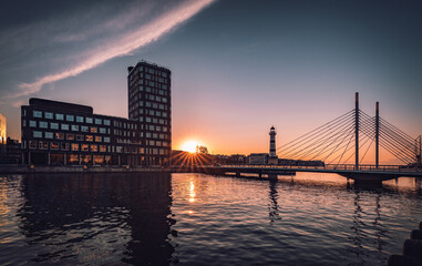 Summer sunset with University bridge and the old lighthouse from 1878 in Malmo, Sweden.