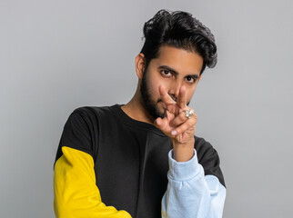 I am watching you. Young confident indian man pointing at his eyes and camera, show I am watching...