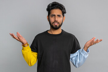 What Why. Sincere irritated indian man raising hands in indignant expression asking reason of...