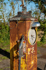 A rusty and disused petrol pump by the side of a minor road in Wiltshire, UK