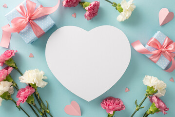Obraz na płótnie Canvas Mother's Day surprise present concept. Top view flat lay photo of beautiful present boxes with pink ribbons, carnation flowers, and pink paper hearts on pastel blue background with empty heart