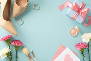 Charming top view flat lay photo of high-heels, earrings, makeup brushes, a gift box, and carnation flowers with a postcard on a pastel blue background with empty space