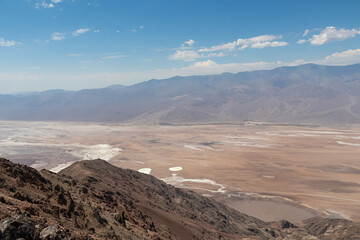 Fototapeta na wymiar Scenic view of Salt Badwater Basin and Panamint Mountains seen from Dante View in Death Valley National Park, California, USA. Coffin Peak, along crest of Black Mountains, overlooking desert landscape