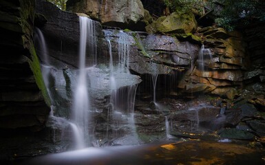 Fototapeta premium Small waterfall flowing over the rocks