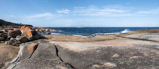 Orange-hued granite rocks in the Bay Of Fires on the northeastern coast of Tasmania in Australia. Panoramic view © Henk Vrieselaar