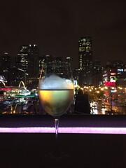 glass of wine with city lights