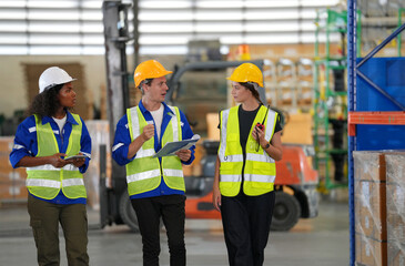 Multiethnic industrial workers checking their logistic lists while working with transportation of...
