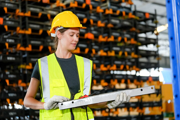 woman worker or supervisor controlling stock in a warehouse.