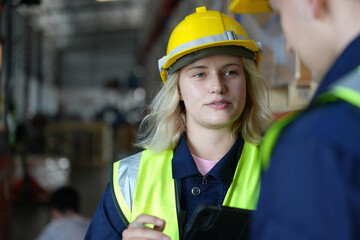 woman worker or supervisor controlling stock in a warehouse.