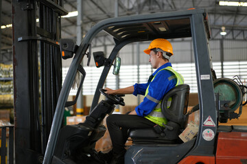 Man forklift driver working in a warehouse.