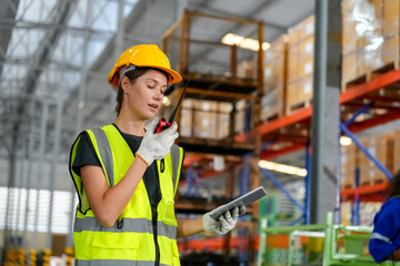 Multiethnic industrial workers checking their logistic lists while working with transportation of goods in warehouse