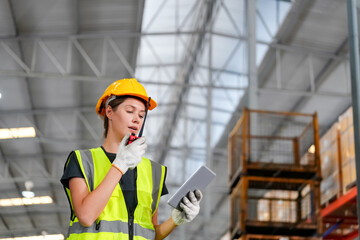 woman worker or supervisor controlling stock in a warehouse.