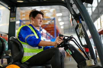 Man forklift driver working in a warehouse.