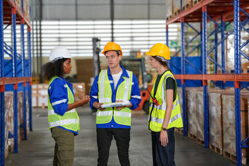 Multiethnic industrial workers checking their logistic lists while working with transportation of goods in warehouse