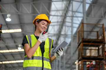 woman worker or supervisor controlling stock in a warehouse.