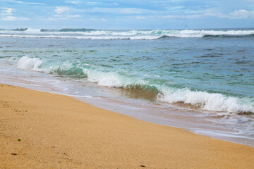 Fototapeta na wymiar Beautiful seascape with sea waves on the sandy beach 
