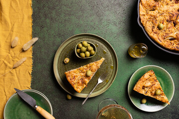 Delicious focaccia bread piece with green olives served on plate