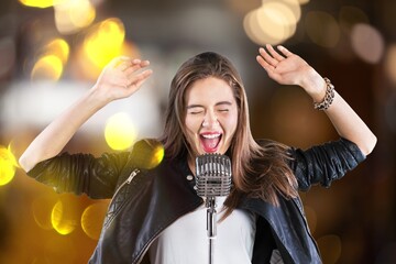 A young happy woman singing in karaoke. - obrazy, fototapety, plakaty