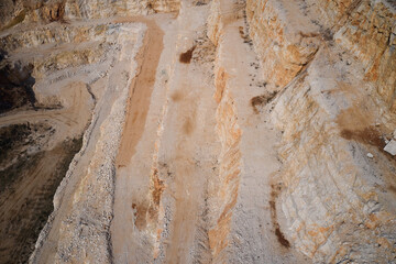 Quarry section. Quarry wall in the mountains. Brown marble quarries. Italian marble quarries. Marble quarry at sunset. Marble quarries.