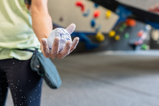 Climber with chalk ball in climbing center