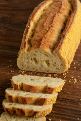 Slices of homemade fresh baked loaf of corn bread on a cutting board close up  