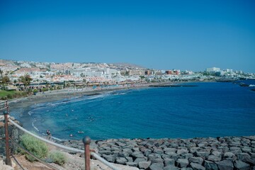 Fototapeta na wymiar Seascape of a calm blue water with coastline path on a sunny day