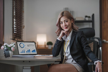 Cheerful business lady working on laptop in office, Asian happy beautiful businesswoman in formal...