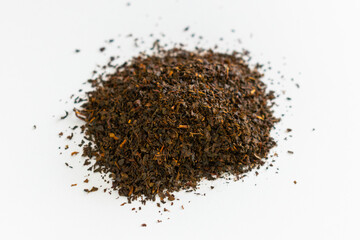 Ceylon black tea.. Scattered black tea on a white background. Isolated. Close up. Dried herbs. Top view.