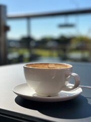 cup of coffee on table with a blurred background. 