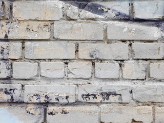 Old brick wall texture background. Brickwork, masonry, paint, stone, facade, architecture, rough surface close-up.