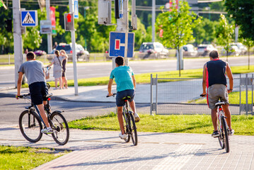 Fototapeta premium Cyclists ride on the bike path in the city Park 