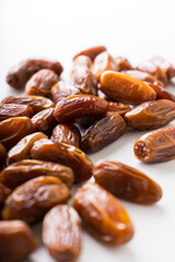 Fresh dried dates fruit on white isolated background. 