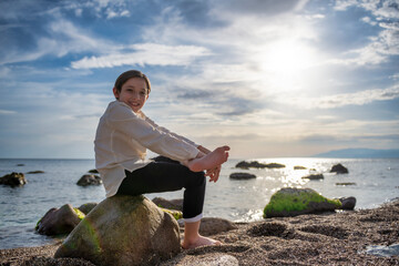 Serene Sunset: A Child's Joyful Sojourn by the Seaside