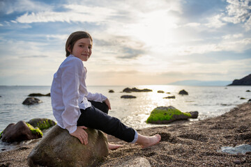 Tranquil Tides and Rockside Rhapsody: A Boy's Beachside Bliss