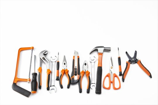 Top view of an orange and black mechanic hand tool set against a white background