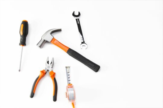 Top view of an orange and black mechanic hand tool set against a white background
