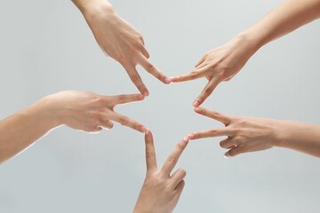 People forming a star shape with their fingers. Concept of teamwork.