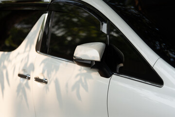 Side view door mirror of luxury new white car. car door handle and key