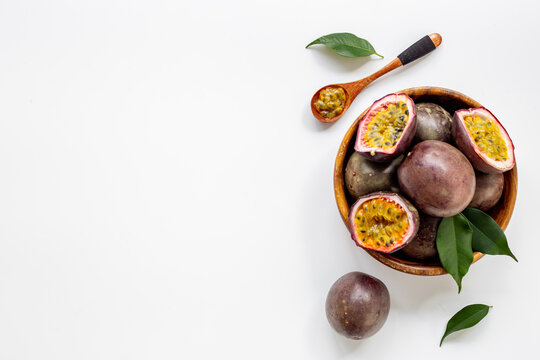 Ripe fresh passion fruit - marakuya - in wooden bowl. Top view