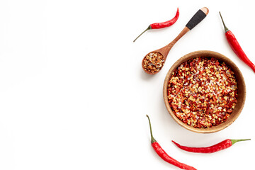 Bowl of hot chili powder and red ripe pepper. Spicy food concept
