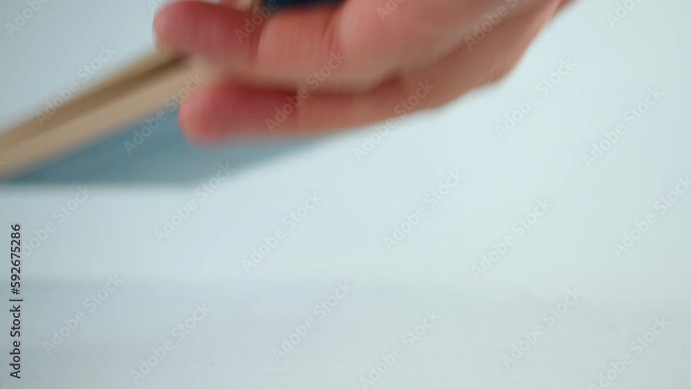 Poster closeup view of a person hand taking a notebook with pen from the table