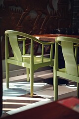 Vertical of green chairs indoors  with sunlight on