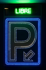 Vertical shot of the neon sign showing the free parking place in Madrid Spain