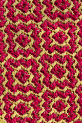 Knitted texture with yellow magenta geometric ethnic pattern. Crochet mosaic pattern. Rhombus and square pattern. Arabic pattern.