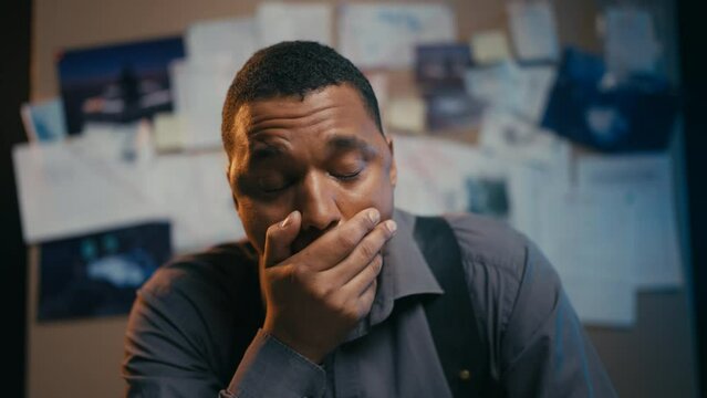 African American policeman feeling exhausted at work, no energy and motivation