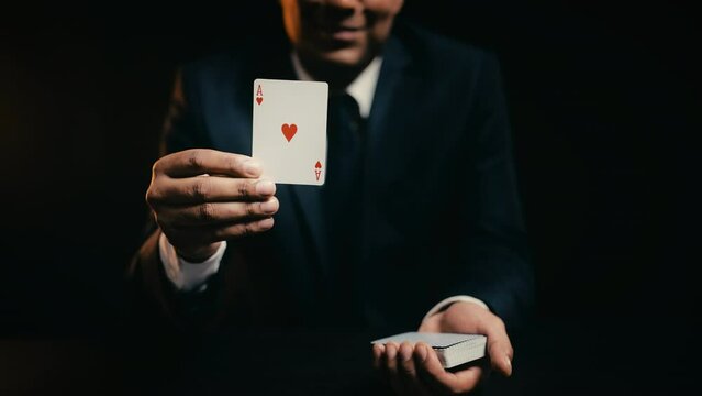 African American man showing ace of hearts, good poker hand, casino victory