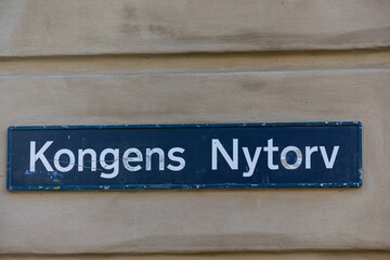 Copenhagen, Denmark A street sign for Kongens Nytorv on the side of a building, a landmark square in the center of town.