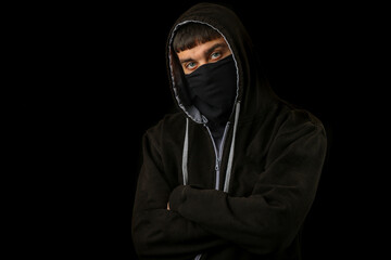 Teenage boy in a mask and hoodie